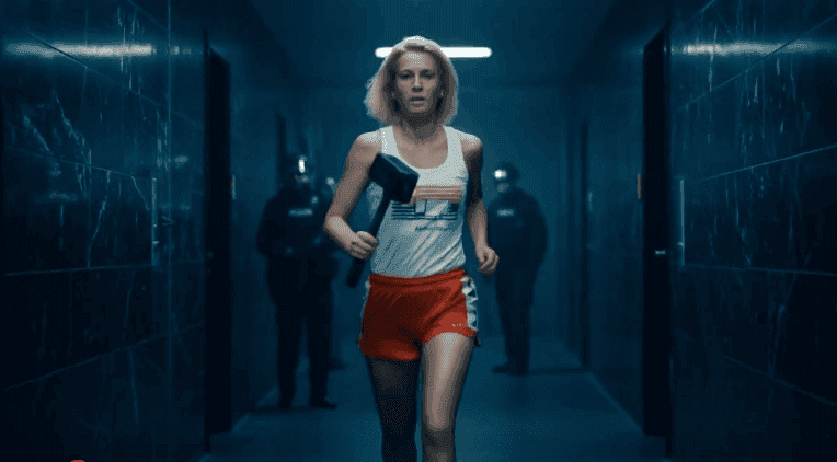 A person running in a hallway with a hammer